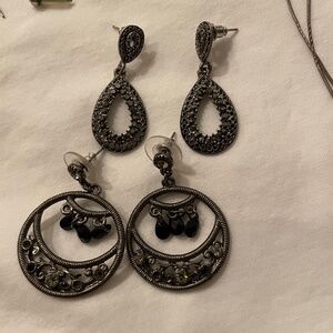 Elegant black earrings with intricate design.